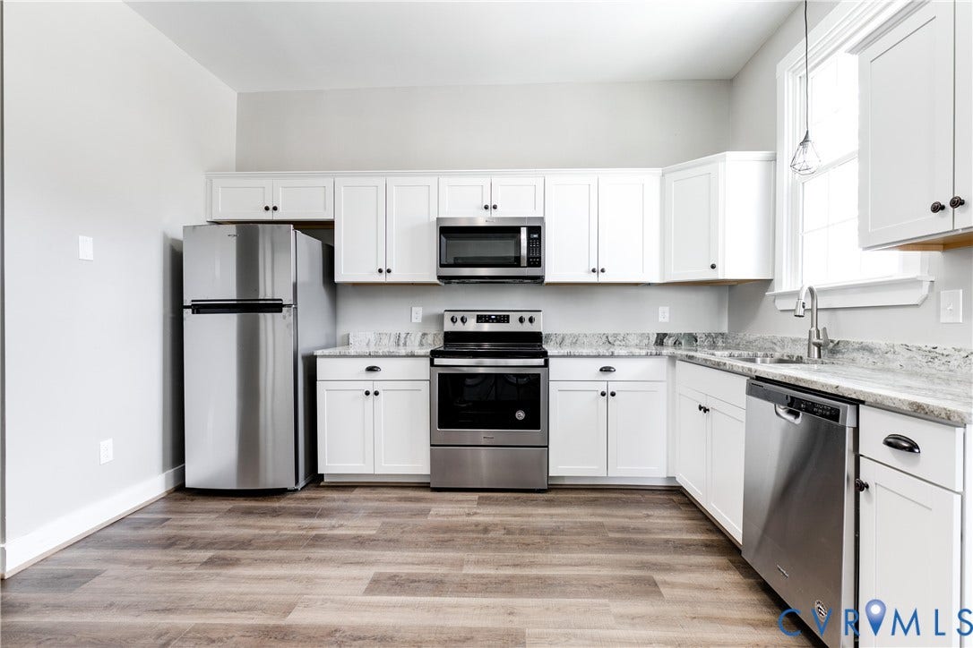 620 Chimborazo Boulevard, Church Hill, Richmond, VA 23223 Kitchen featuring white shaker-style cabinetry, stone-surface countertops, stainless steel appliances, and wood-finish flooring