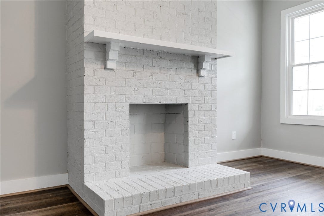620 Chimborazo Boulevard, Church Hill, Richmond, VA 23223 Floor-to-ceiling painted brick fireplace featuring a wood mantel, a raised brick hearth, and wood-finish flooring