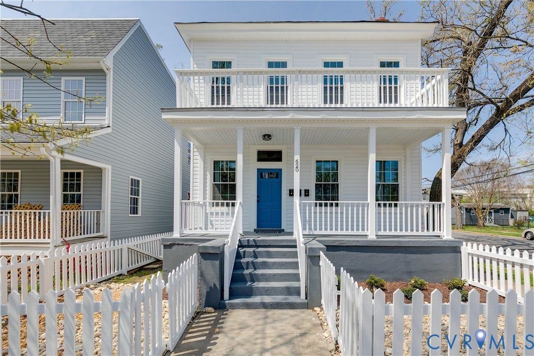 620 Chimborazo Boulevard, Church Hill, Richmond, VA 23223 Two-story exterior featuring white horizontal siding, a covered full-width front porch, an upper-level balcony with railings, and a solid blue entry door