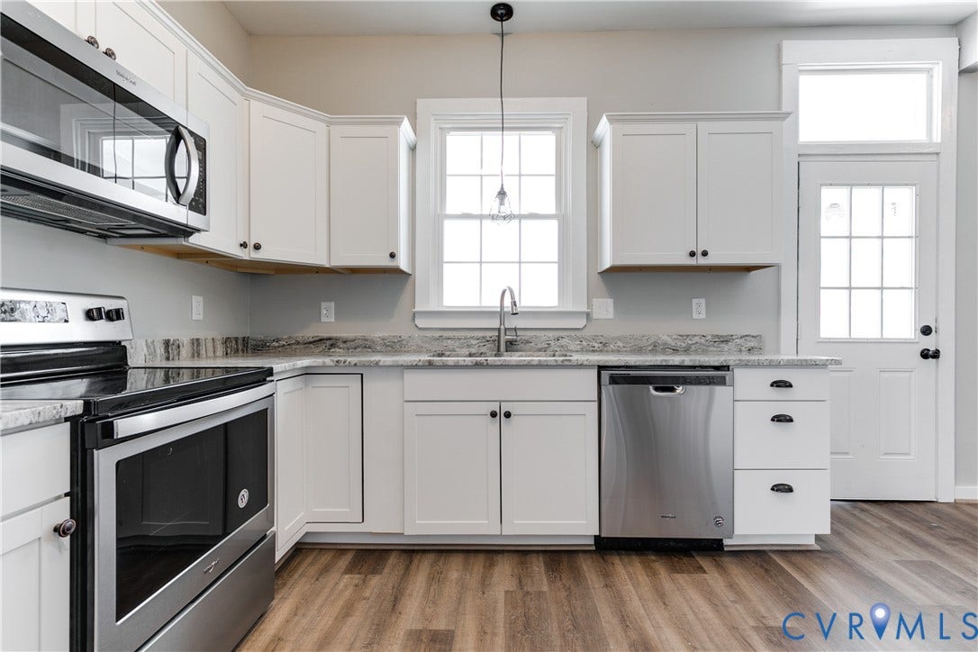 620 Chimborazo Boulevard, Church Hill, Richmond, VA 23223 Kitchen featuring white cabinetry, stone-finish countertops, stainless steel appliances, wood-finish flooring, and a single-light pendant fixture