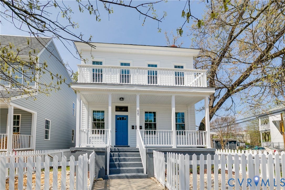 620 Chimborazo Boulevard, Church Hill, Richmond, VA 23223 Two-story exterior featuring white horizontal siding, a covered front porch with a second-story balcony, and a white picket fence