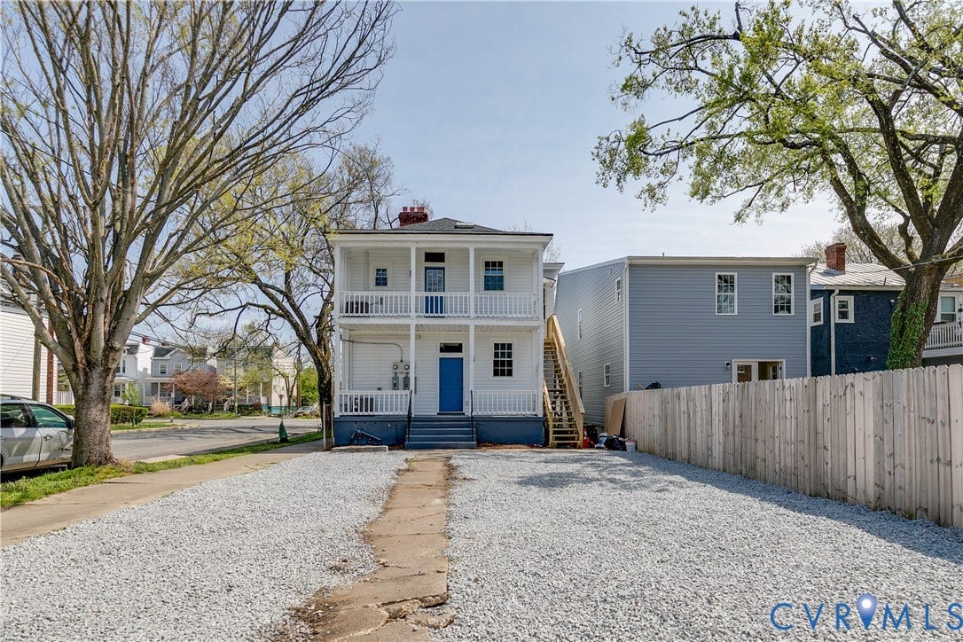 620 Chimborazo Boulevard, Church Hill, Richmond, VA 23223 Two-story exterior featuring a stacked double-tiered porch, white balustrades, concrete walkway, and gravel-surfaced lot