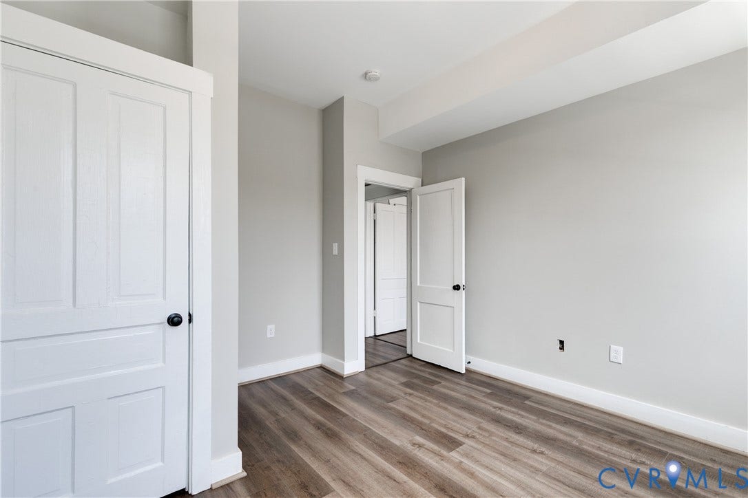620 Chimborazo Boulevard, Church Hill, Richmond, VA 23223 Neutral interior featuring wood-finish flooring, white two-panel doors, and crisp neutral wall paint