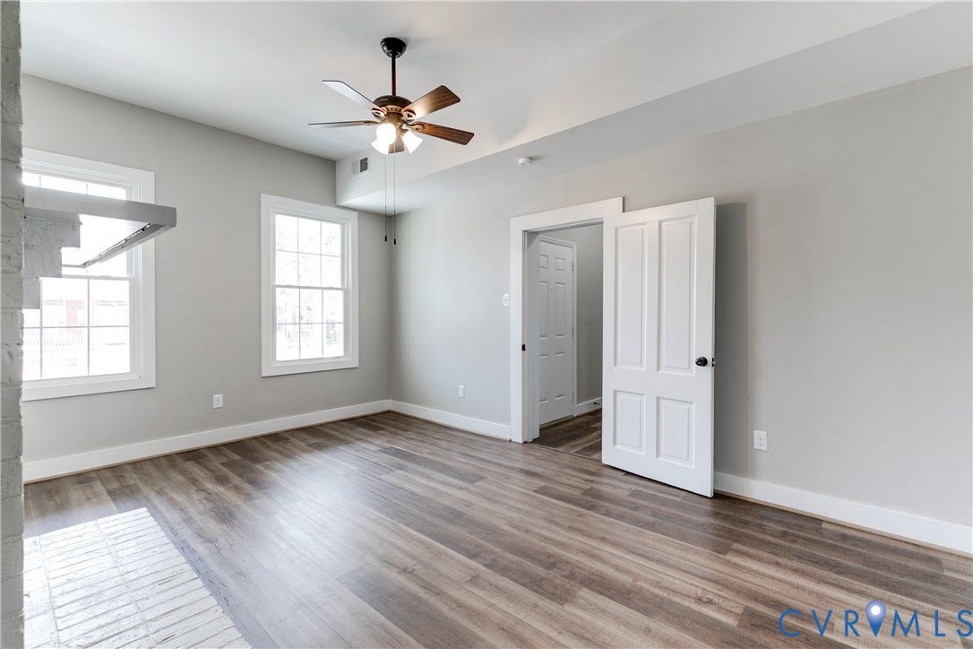 620 Chimborazo Boulevard, Church Hill, Richmond, VA 23223 Interior space featuring wood-finish flooring, multi-pane windows, a central ceiling fan with integrated lighting, and white six-panel interior doors