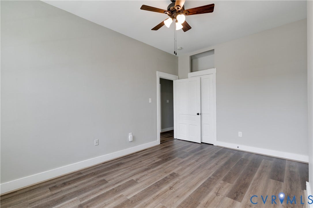 620 Chimborazo Boulevard, Church Hill, Richmond, VA 23223 Room featuring wood-finish flooring, neutral wall paint, a ceiling fan with integrated lighting, and a door with a transom window
