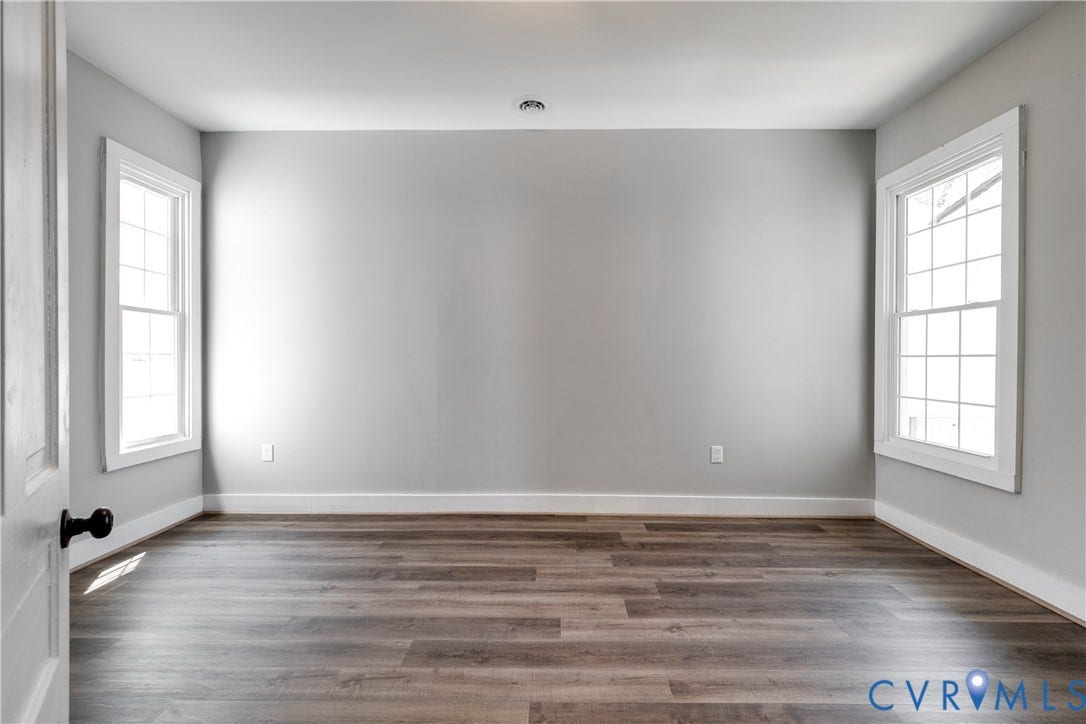 620 Chimborazo Boulevard, Church Hill, Richmond, VA 23223 Interior room featuring wood-finish flooring, neutral wall paint, and dual windows with grid-pattern muntins
