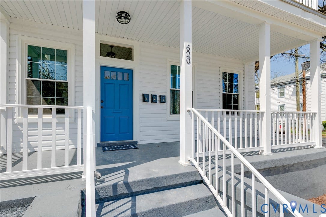 620 Chimborazo Boulevard, Church Hill, Richmond, VA 23223 Covered front porch featuring white lap siding, square support columns, a white railing system, and a blue paneled front door with a transom window