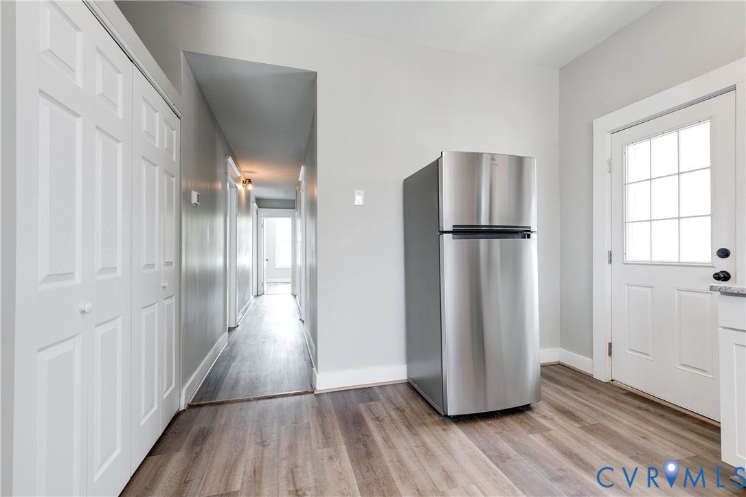 620 Chimborazo Boulevard, Church Hill, Richmond, VA 23223 Stainless steel refrigerator, wood-finish flooring, white paneled closet doors, and a six-lite glass-paneled exterior door