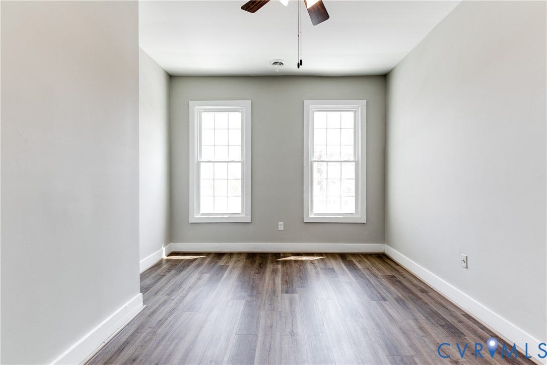 620 Chimborazo Boulevard, Church Hill, Richmond, VA 23223 Neutral-toned interior featuring wood-finish flooring, dual grid-pattern windows, and a ceiling-mounted light fixture