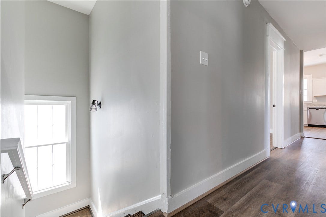 620 Chimborazo Boulevard, Church Hill, Richmond, VA 23223 Wood-finish flooring, neutral wall tones, white door casings, and wall-mounted metal light fixture