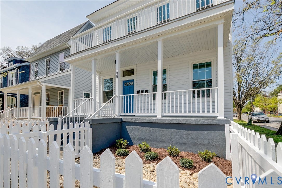 620 Chimborazo Boulevard, Church Hill, Richmond, VA 23223 Two-story exterior featuring white horizontal siding, a covered front porch with a balcony, and a white picket fence