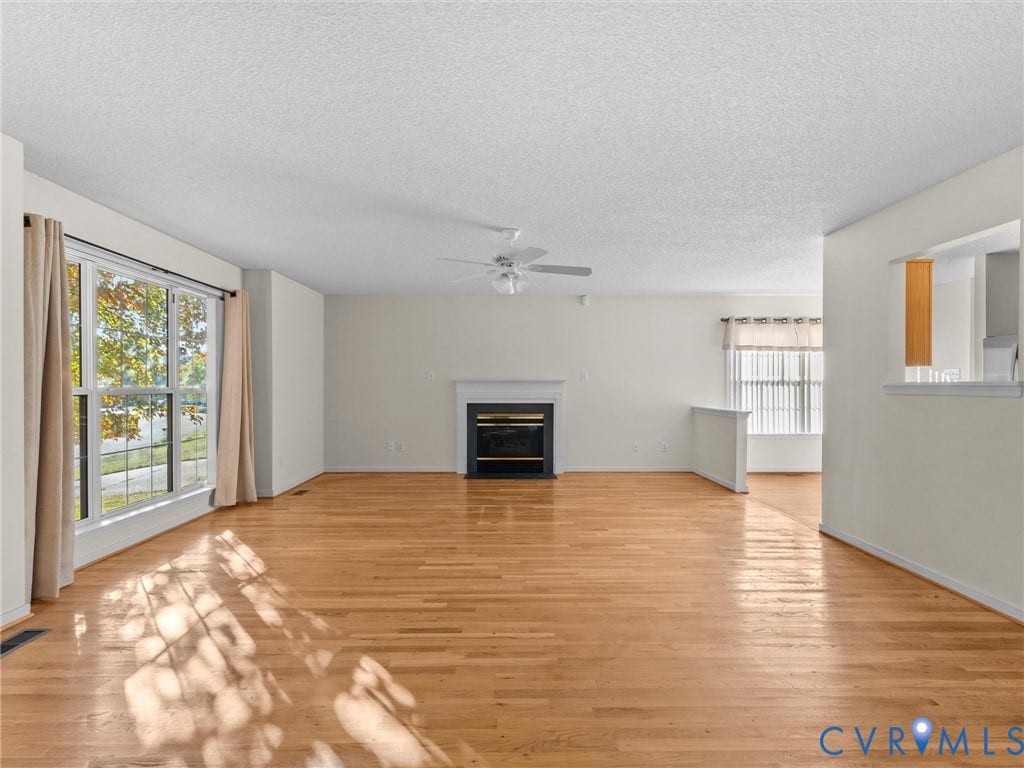 9520 Willow Ridge Drive, Glen Allen, VA 23060 Living area featuring wood-finish flooring, a fireplace with a mantel, ceiling fan, and large windows