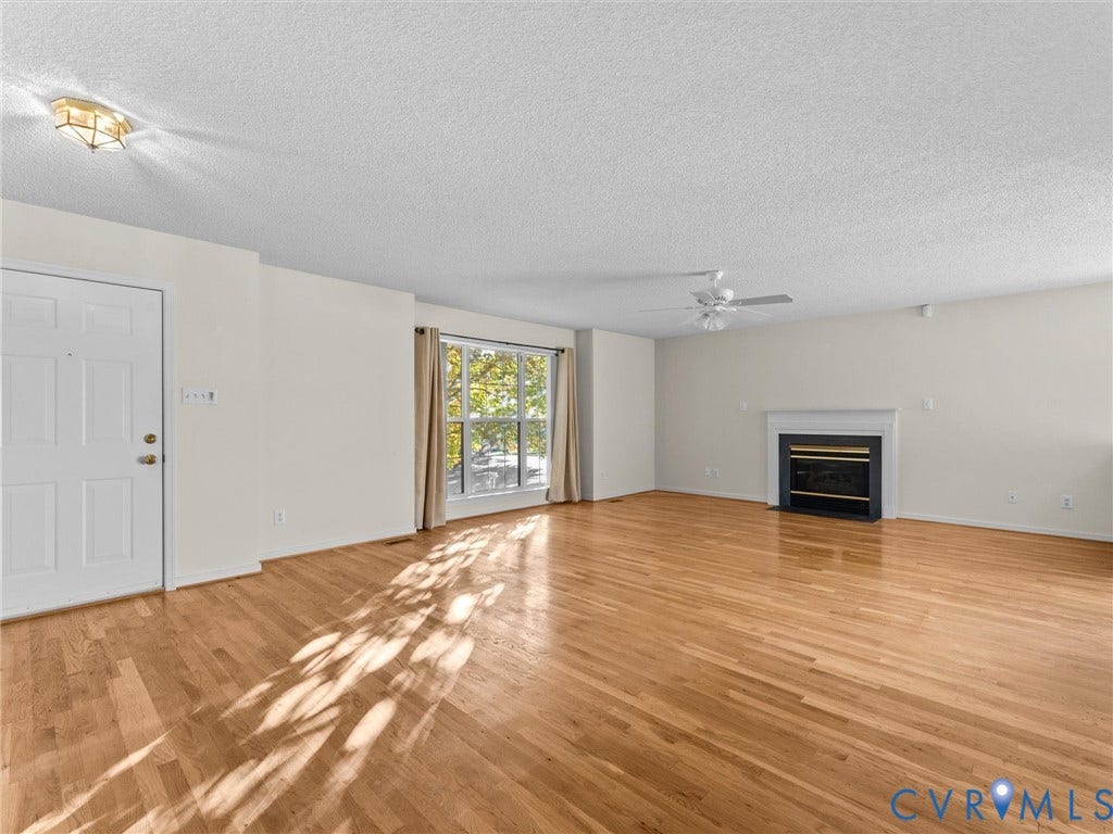 9520 Willow Ridge Drive, Glen Allen, VA 23060 Living area featuring wood-finish flooring, a fireplace with a white mantel, a ceiling fan, and large windows