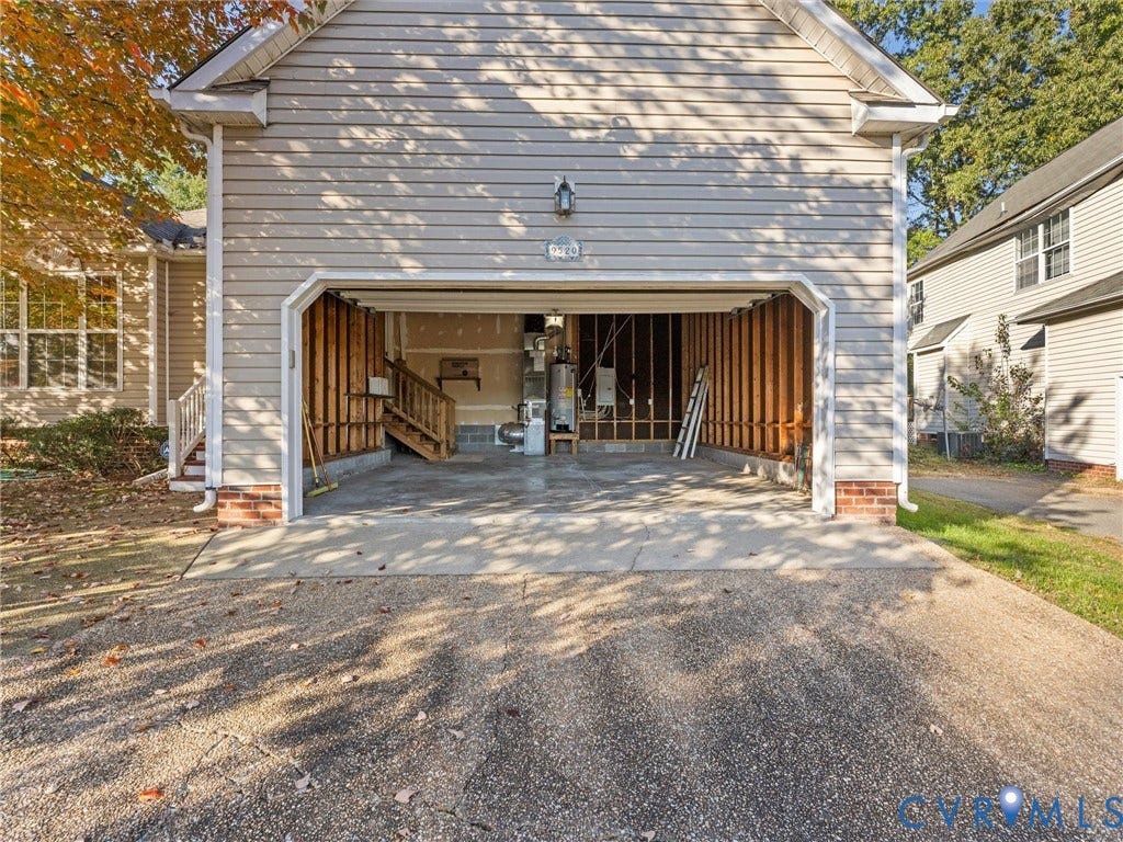 9520 Willow Ridge Drive, Glen Allen, VA 23060 Detached garage with horizontal vinyl siding, brick foundation accents, and an open bay configuration