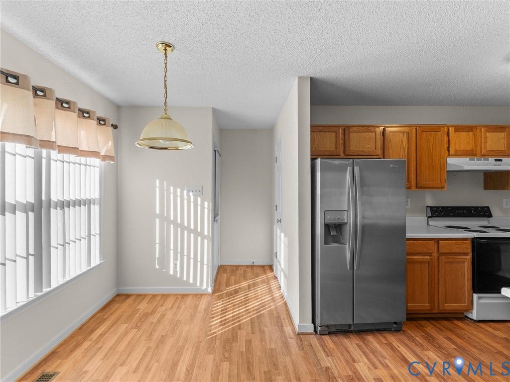 9520 Willow Ridge Drive, Glen Allen, VA 23060 Kitchen featuring natural wood cabinetry, stainless steel side-by-side refrigerator, white range, and wood-finish flooring with a dome pendant light fixture
