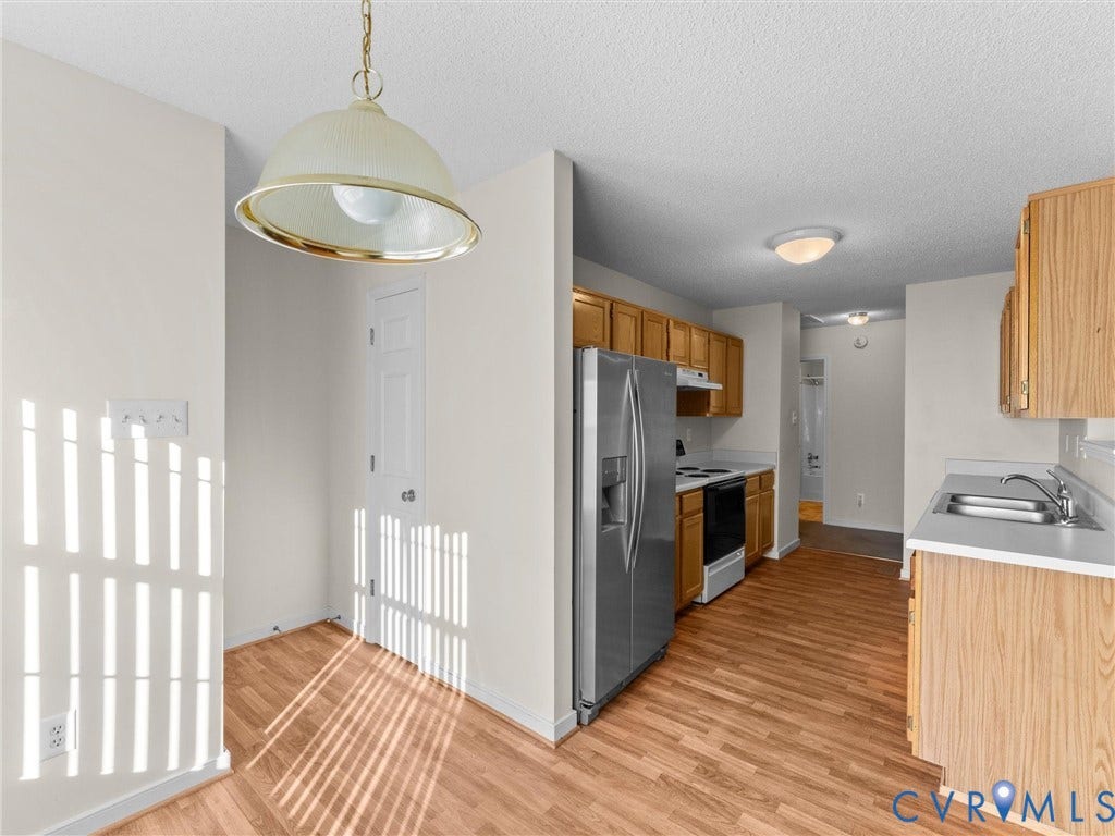 9520 Willow Ridge Drive, Glen Allen, VA 23060 Kitchen featuring wood-finish flooring, stainless steel side-by-side refrigerator, light-tone cabinetry, and a dome-style pendant light fixture