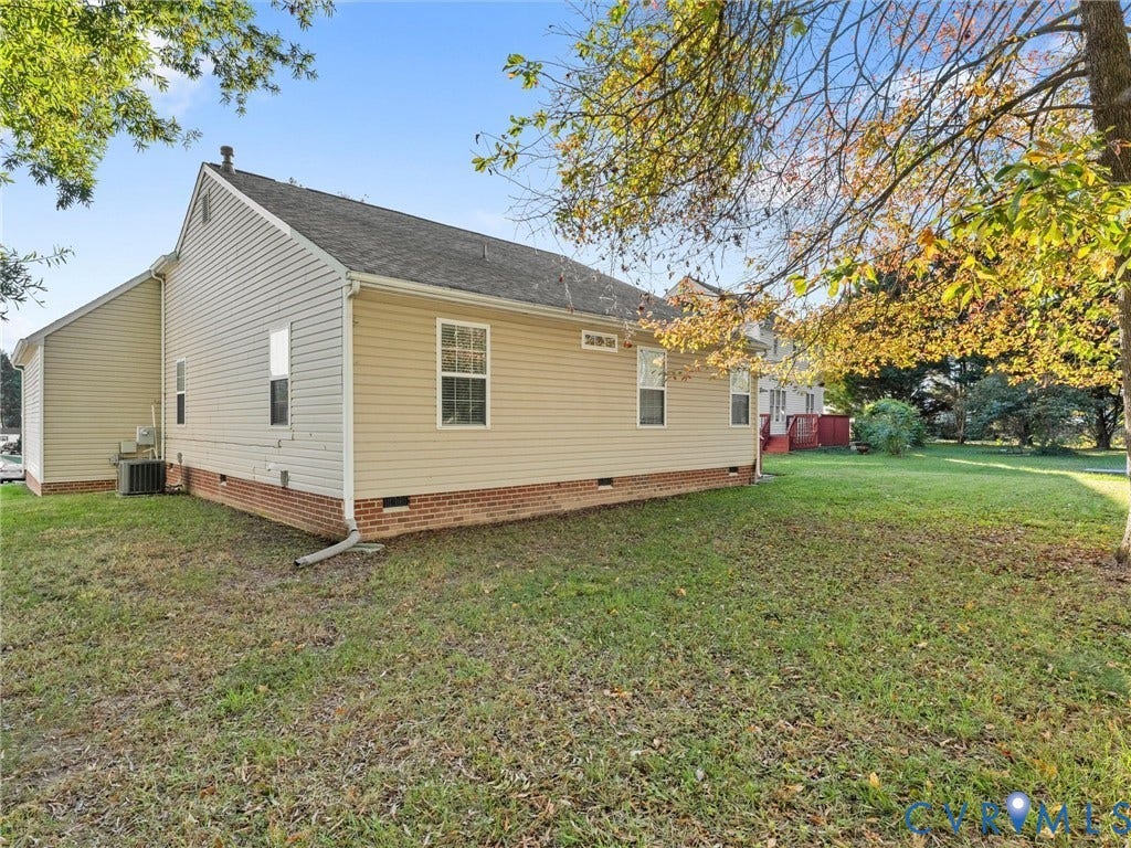 9520 Willow Ridge Drive, Glen Allen, VA 23060 Exterior featuring light-colored horizontal siding, a red brick foundation, and a grassy lot with mature trees