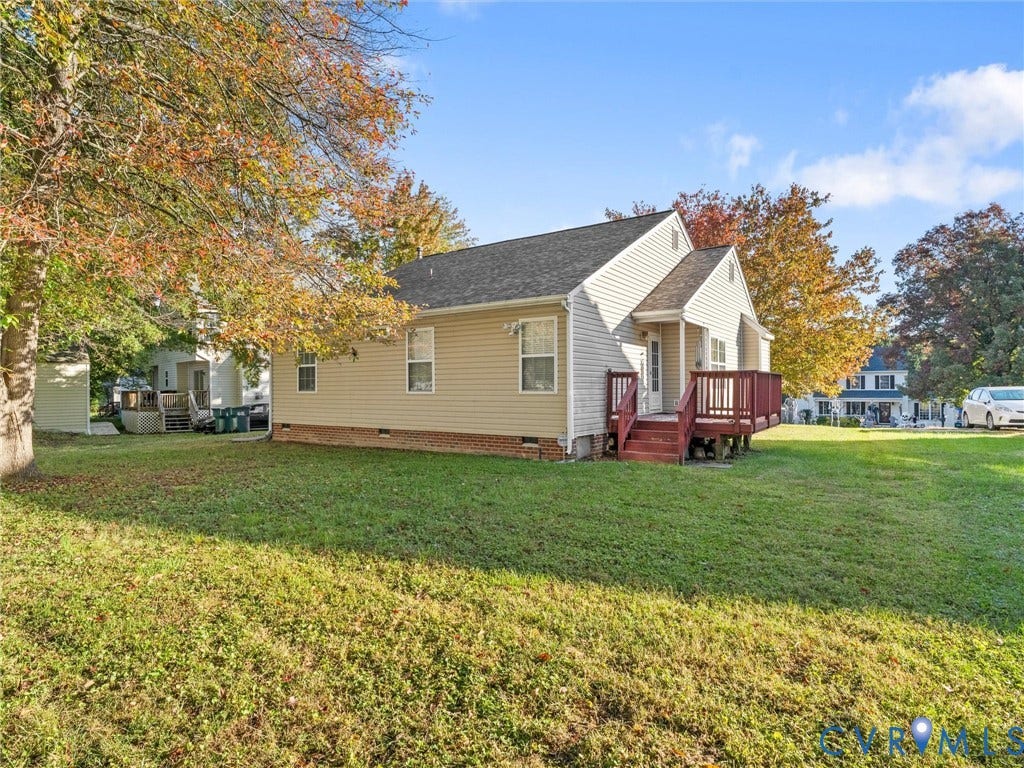 9520 Willow Ridge Drive, Glen Allen, VA 23060 Single-story exterior featuring light-toned horizontal siding, a raised wood-tone deck, a gabled roofline, and a brick foundation perimeter