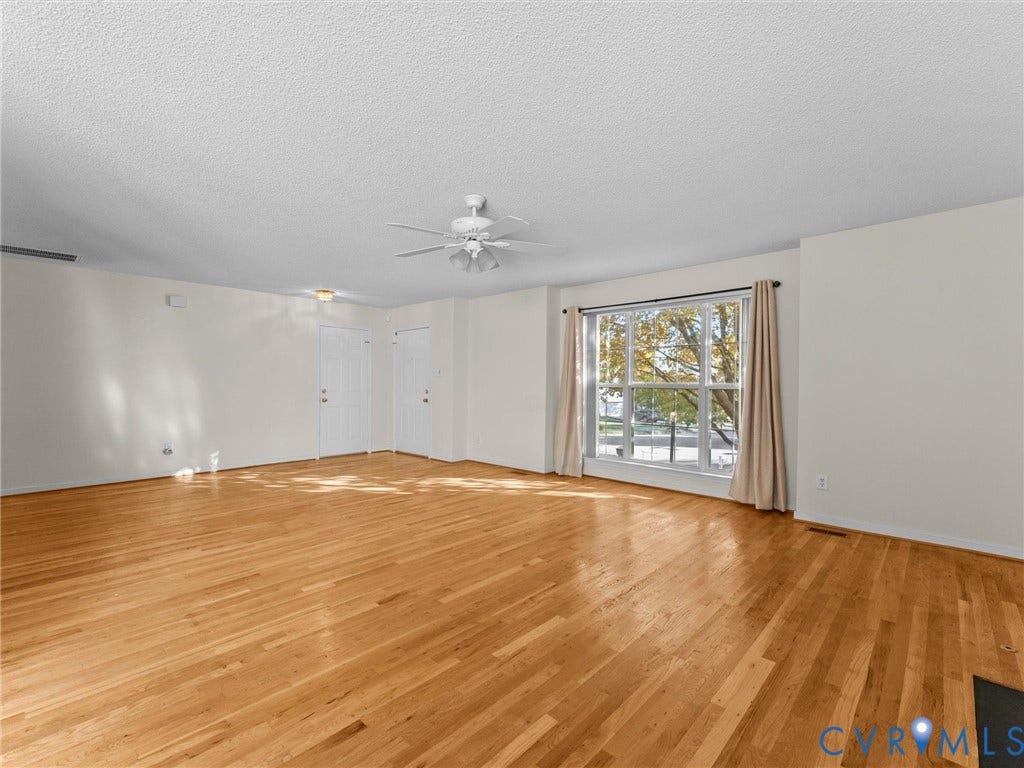 9520 Willow Ridge Drive, Glen Allen, VA 23060 Spacious interior featuring wood-finish flooring, a ceiling fan with integrated lighting, and a large multi-pane window