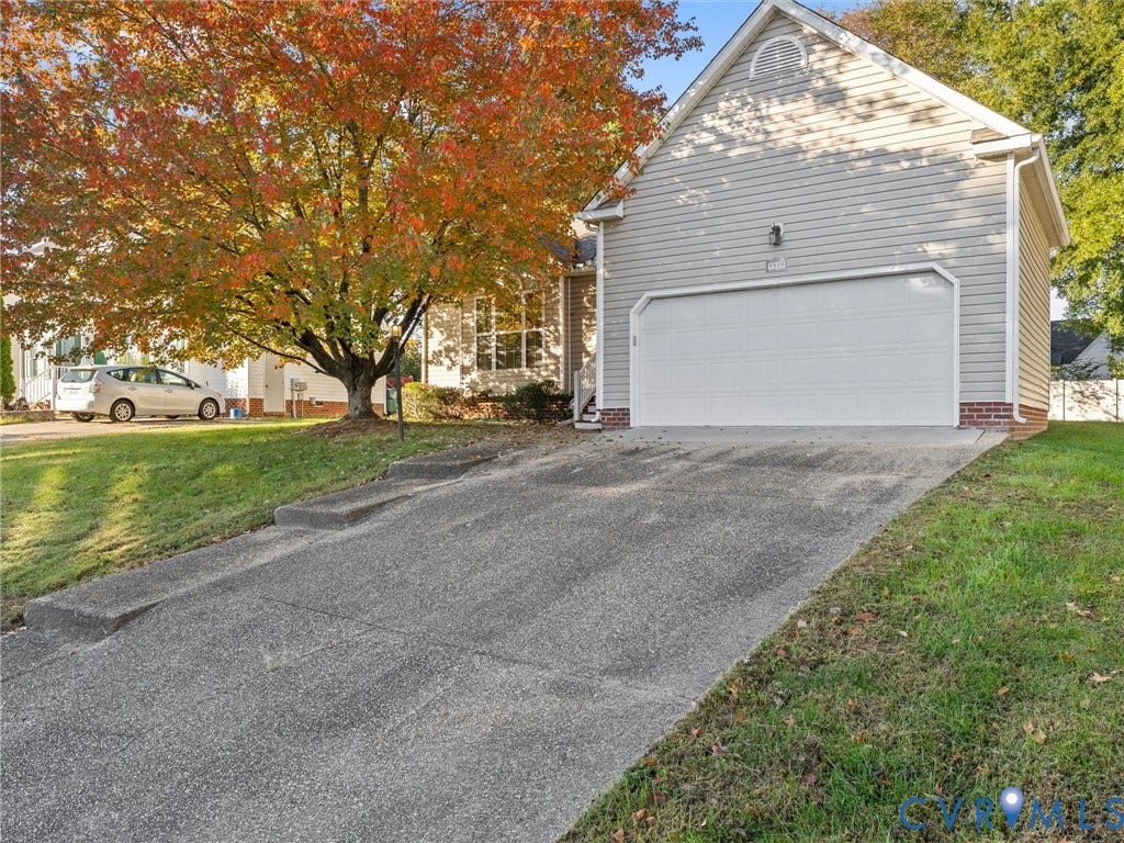 9520 Willow Ridge Drive, Glen Allen, VA 23060 Exterior featuring horizontal siding, a gabled roofline, brick foundation accents, a concrete driveway, and an attached two-car garage