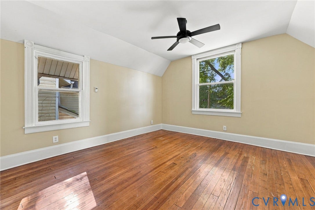 1911 3rd Avenue, Richmond, VA 23222 Room featuring wood-finish flooring, dual windows with white casings, and a black ceiling fan