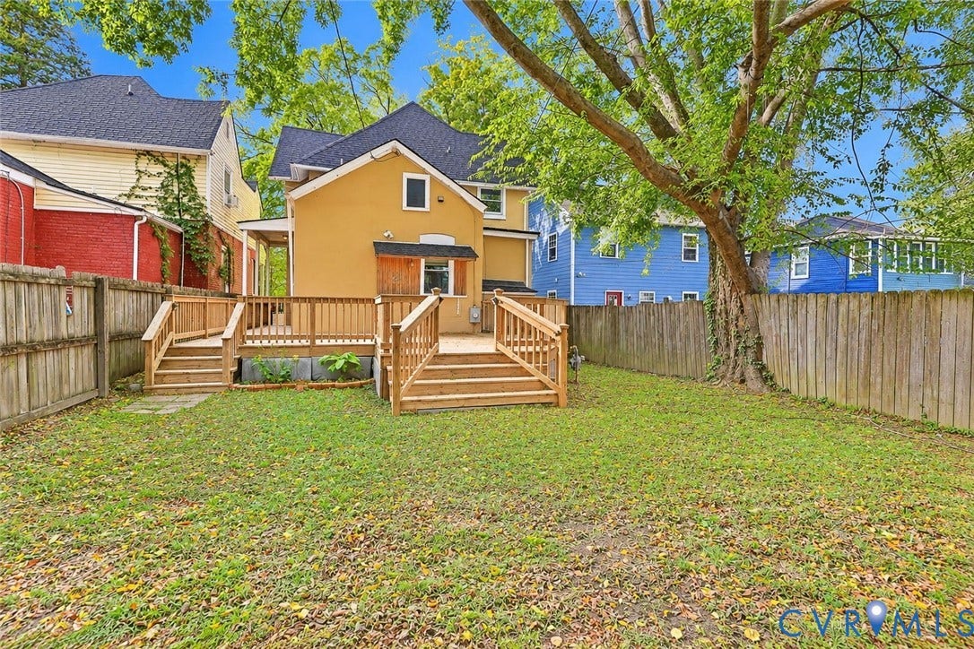 1911 3rd Avenue, Richmond, VA 23222 Backyard featuring a raised wooden deck with railings, wooden privacy fencing, and mature trees