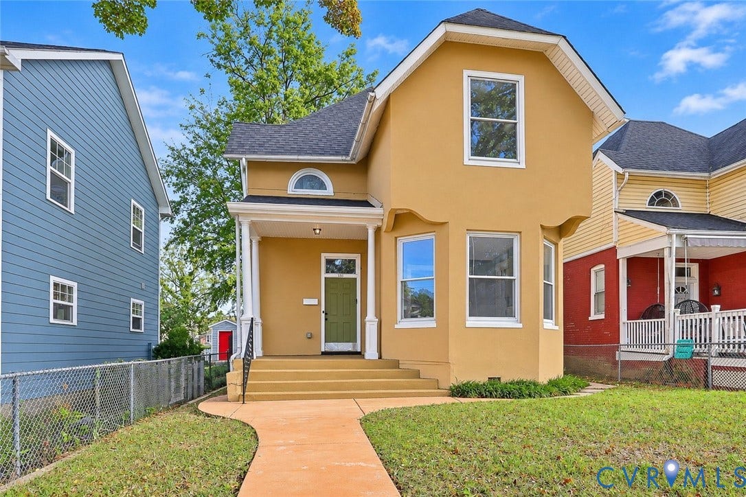 1911 3rd Avenue, Richmond, VA 23222 Stucco exterior with a prominent bay window, covered front porch, arched accent window, and asphalt shingle roof