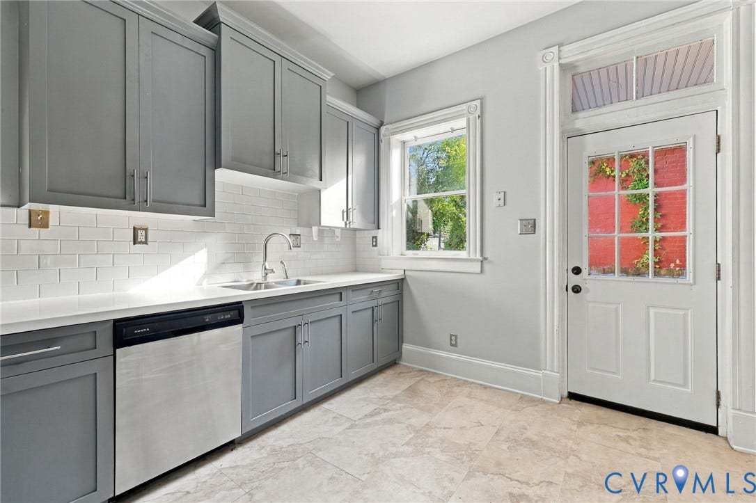 1911 3rd Avenue, Richmond, VA 23222 Kitchen featuring gray shaker-style cabinetry, white subway tile backsplash, solid surface countertops, stainless steel dishwasher, and stone-finish tile flooring