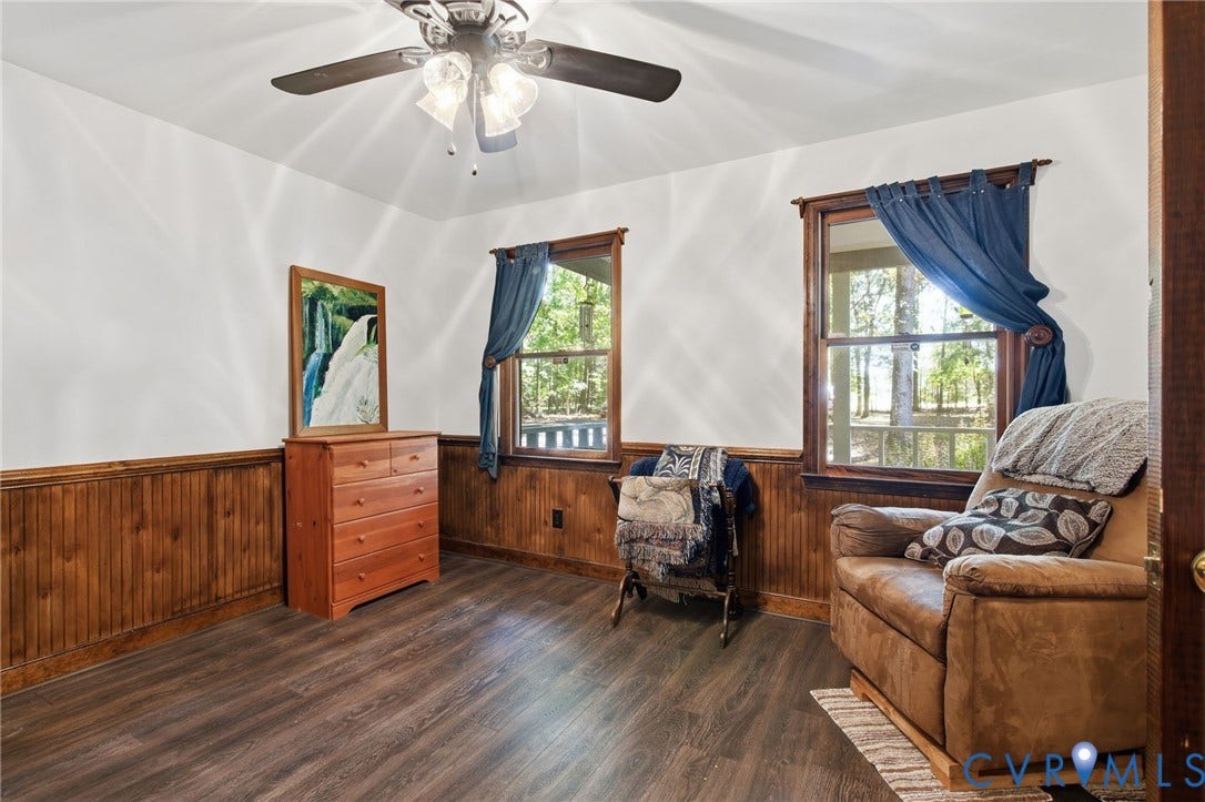1330 Ruffin Mill Road, South Chesterfield, VA 23834 Interior room featuring wood-finish flooring, wood wainscoting, dual windows, and an attached multi-light ceiling fan
