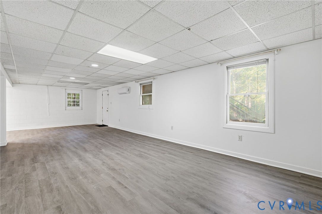 1330 Ruffin Mill Road, South Chesterfield, VA 23834 Open-concept interior featuring wood-finish flooring, a suspended drop ceiling, recessed lighting, and a wall-mounted ductless climate control unit