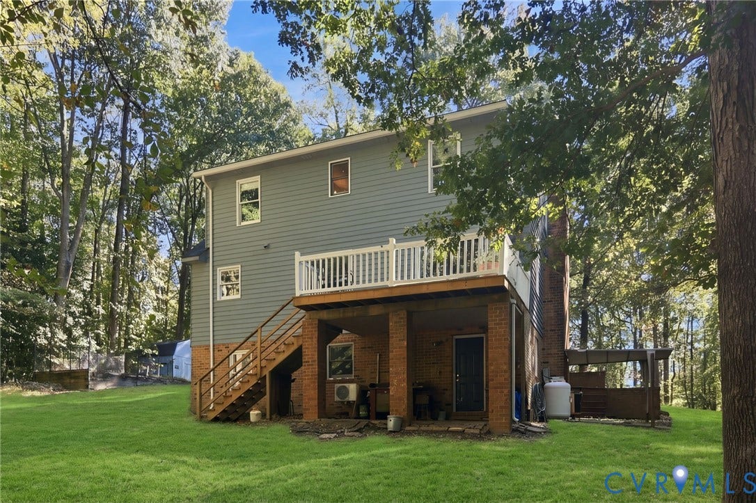 1330 Ruffin Mill Road, South Chesterfield, VA 23834 Exterior featuring a multi-level structure with a raised deck, brick-column foundation, wood-framed staircase, and light-tone siding