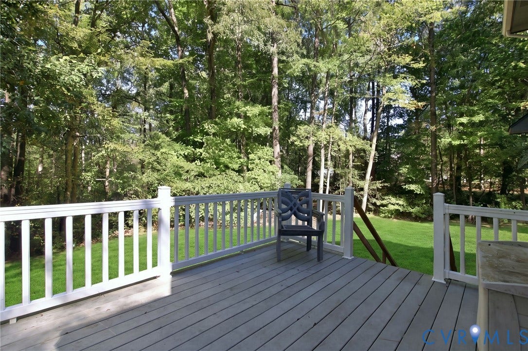 1330 Ruffin Mill Road, South Chesterfield, VA 23834 Elevated wood-finish deck with white railings, mature trees, and open lawn space