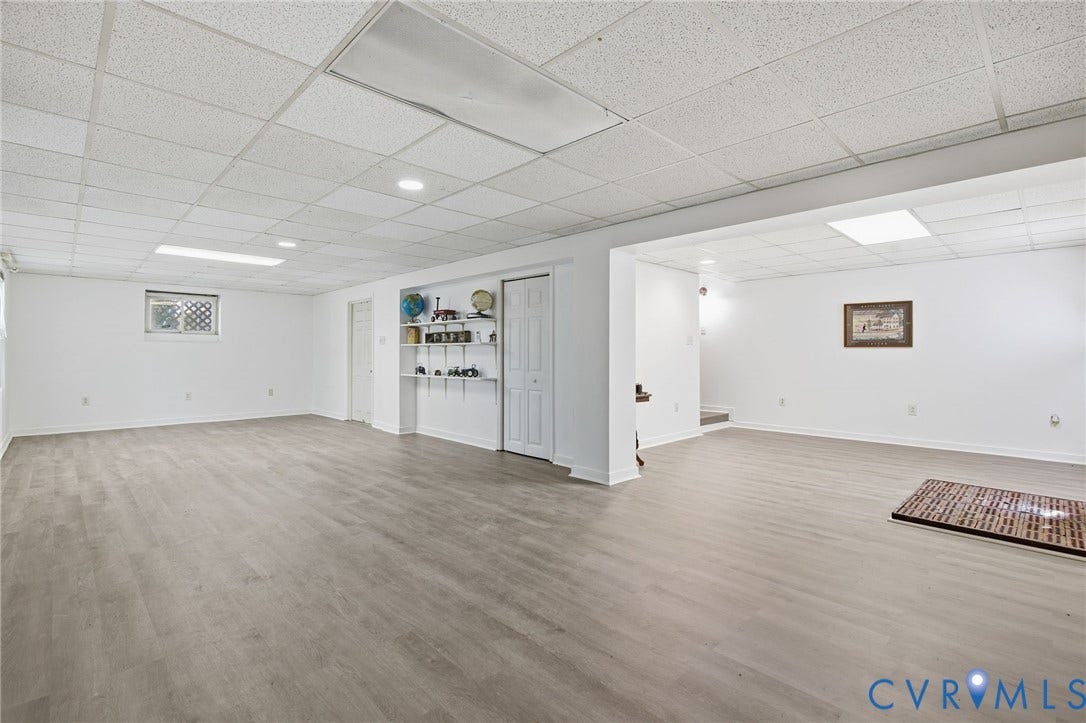1330 Ruffin Mill Road, South Chesterfield, VA 23834 Expansive finished area featuring wood-finish flooring, a suspended acoustic tile ceiling, recessed lighting, and built-in wall shelving