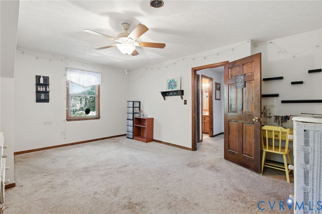 1330 Ruffin Mill Road, South Chesterfield, VA 23834 Interior room featuring wall-to-wall carpeting, a ceiling fan with integrated light fixture, a single-hung window, and a solid wood six-panel door