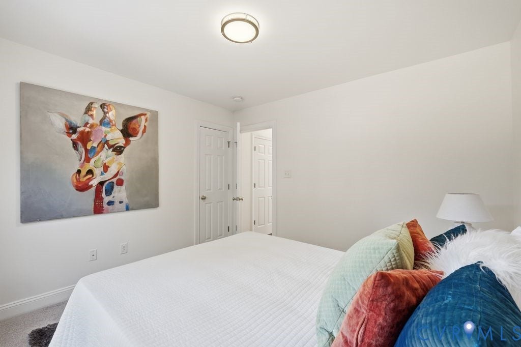8477 Cheraw Road, Mechanicsville, VA 23116 Neutral-toned room featuring wall-to-wall carpeting, a multi-panel interior door, and a flush-mount circular ceiling fixture