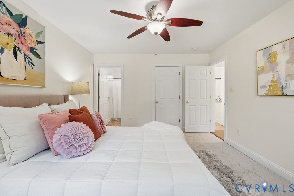8477 Cheraw Road, Mechanicsville, VA 23116 Neutral wall paint, ceiling fan with light kit, carpeted flooring, and six-panel interior doors