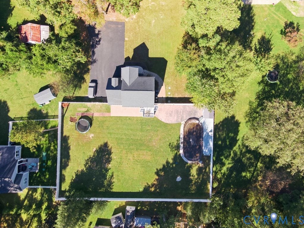 8477 Cheraw Road, Mechanicsville, VA 23116 Aerial perspective of a property featuring a fenced backyard, an in-ground pool, a paved patio, and a driveway