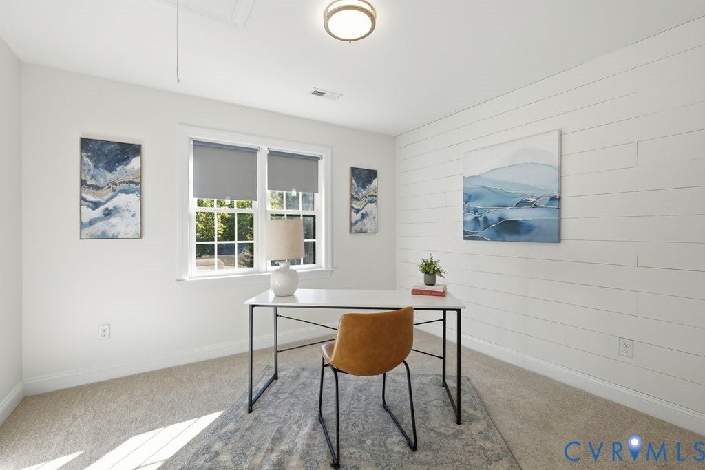 8477 Cheraw Road, Mechanicsville, VA 23116 Room featuring horizontal shiplap accent wall, neutral carpeting, and a multi-pane window with roller shades, illuminated by a modern flush-mount light fixture