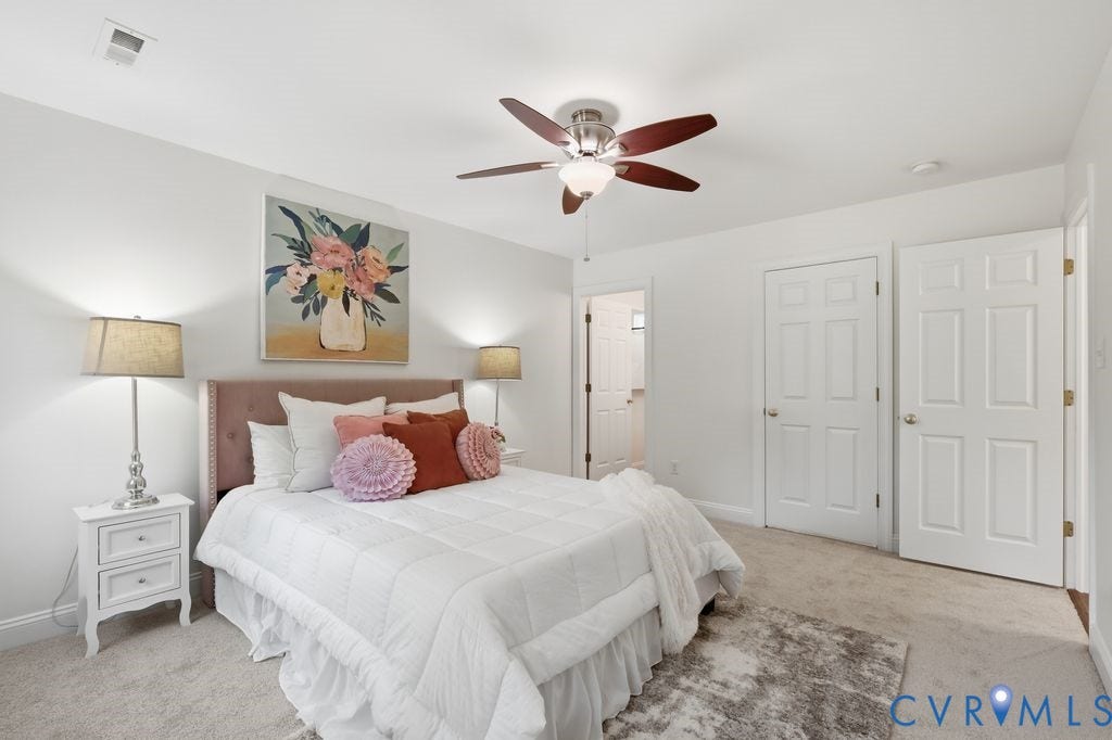 8477 Cheraw Road, Mechanicsville, VA 23116 Neutral interior featuring wall-to-wall carpeting, a multi-blade ceiling fan with integrated lighting, and two six-panel interior doors