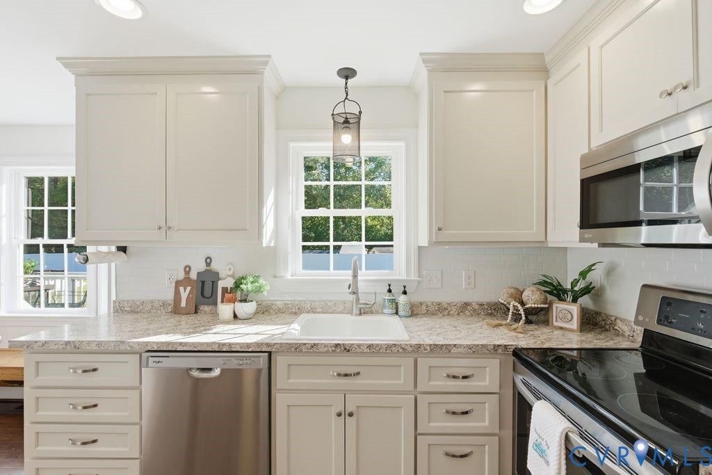 8477 Cheraw Road, Mechanicsville, VA 23116 Shaker-style cabinetry, stone-finish countertops, white subway tile backsplash, stainless steel appliances, and a single-basin undermount sink