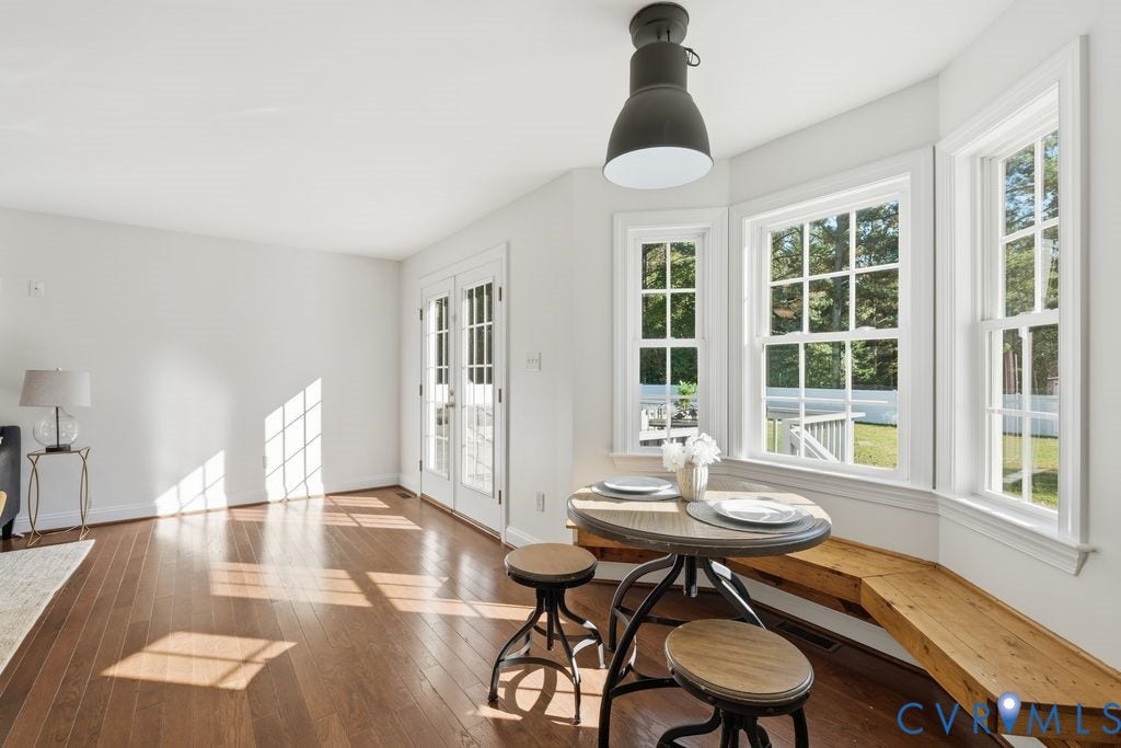 8477 Cheraw Road, Mechanicsville, VA 23116 Wood-finish flooring, bay windows with custom built-in bench seating, pendant lighting, and multi-light French doors