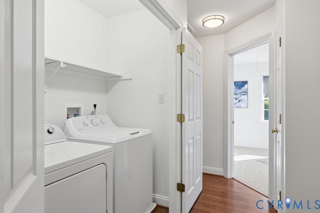 8477 Cheraw Road, Mechanicsville, VA 23116 Dedicated laundry space featuring white washer and dryer hookups, overhead shelving, a flush-mount ceiling light fixture, and wood-finish flooring