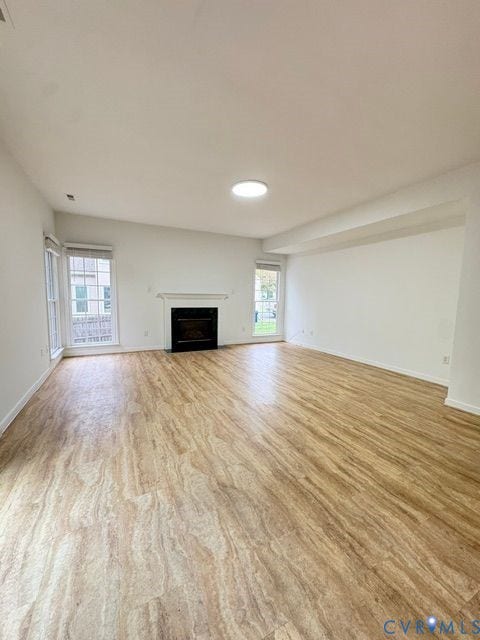 9504 Hungary Woods Drive, Glen Allen, VA 23060 Interior space featuring wood-finish flooring, a built-in fireplace with a mantel, and multi-pane windows