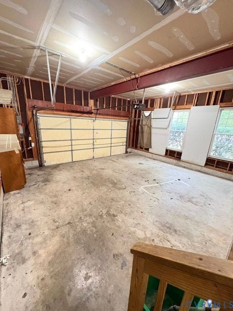 9504 Hungary Woods Drive, Glen Allen, VA 23060 Multi-car garage featuring a concrete floor, steel support beam, overhead automatic door, and double-pane windows