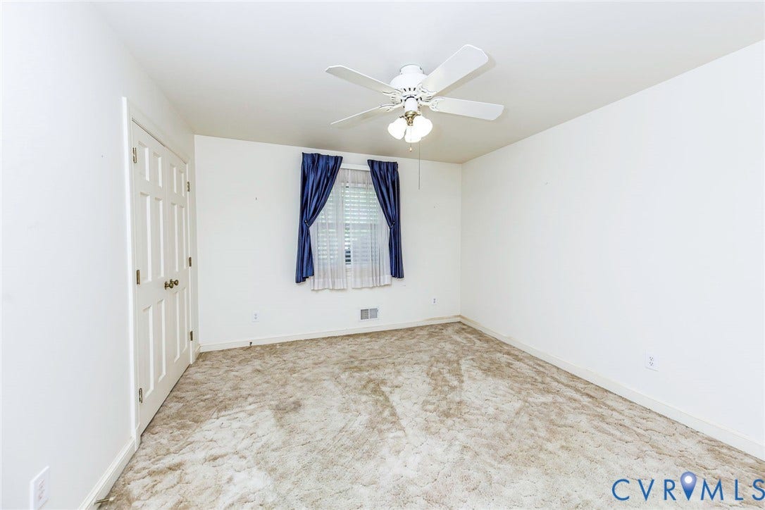 4511 Inca Drive, Ampthill, VA 23237 Neutral interior featuring carpeting, a multi-panel door, and a ceiling fan with integrated lighting