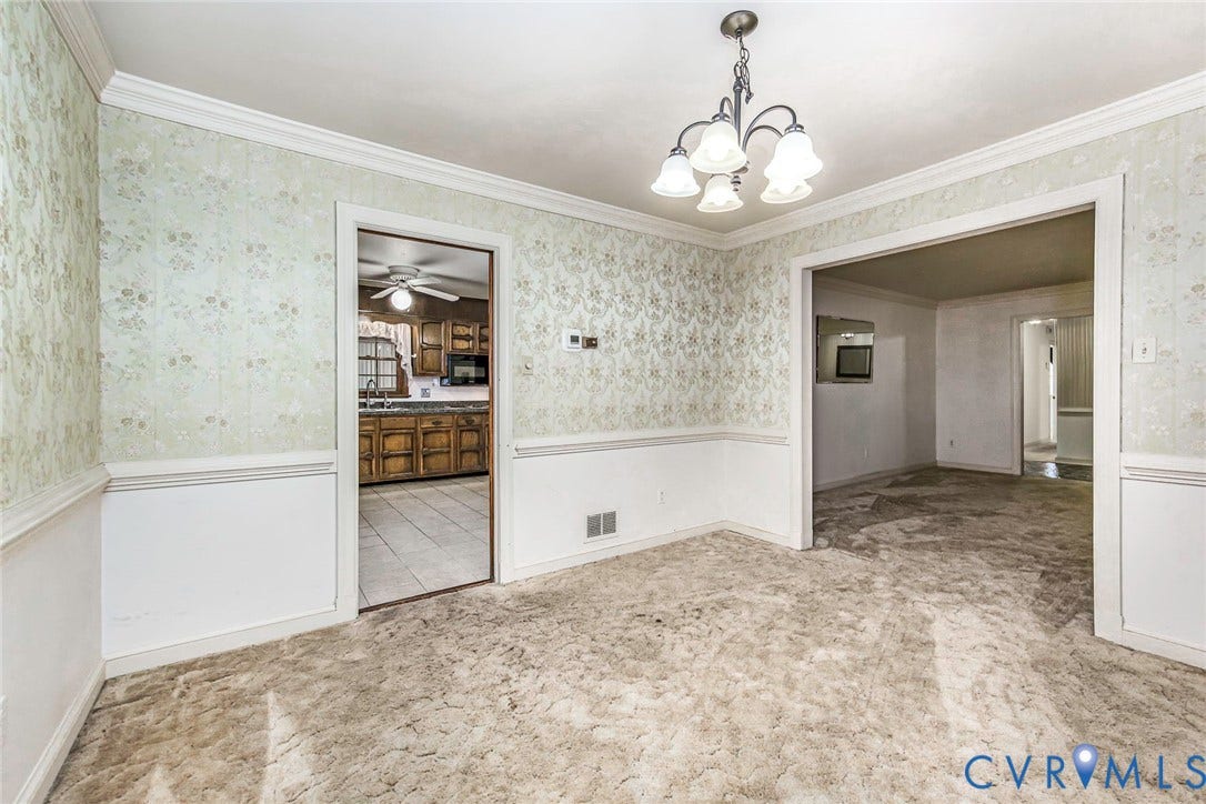 4511 Inca Drive, Ampthill, VA 23237 Formal dining area featuring crown molding, chair rail millwork, wallpapered walls, and a multi-arm overhead light fixture