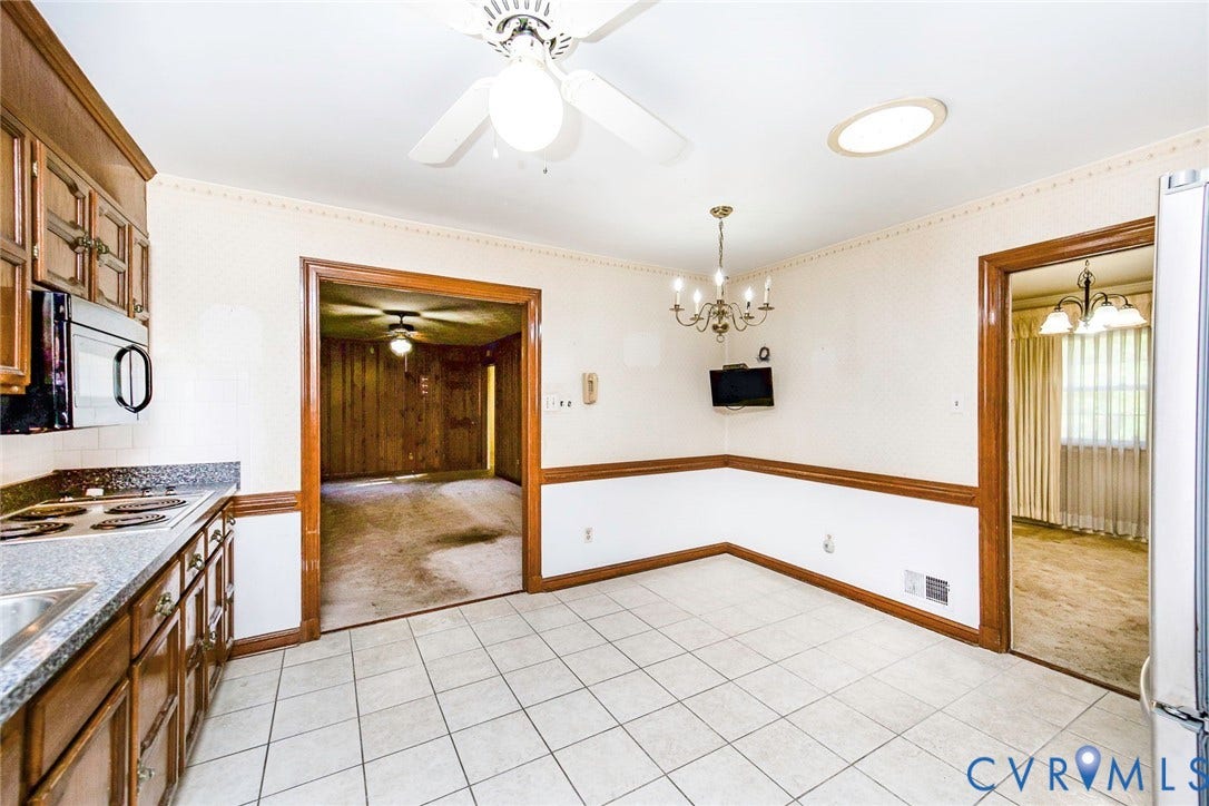 4511 Inca Drive, Ampthill, VA 23237 Kitchen area featuring square tile flooring, wood-toned cabinetry, a built-in microwave, a ceiling fan with integrated lighting, and a multi-arm chandelier