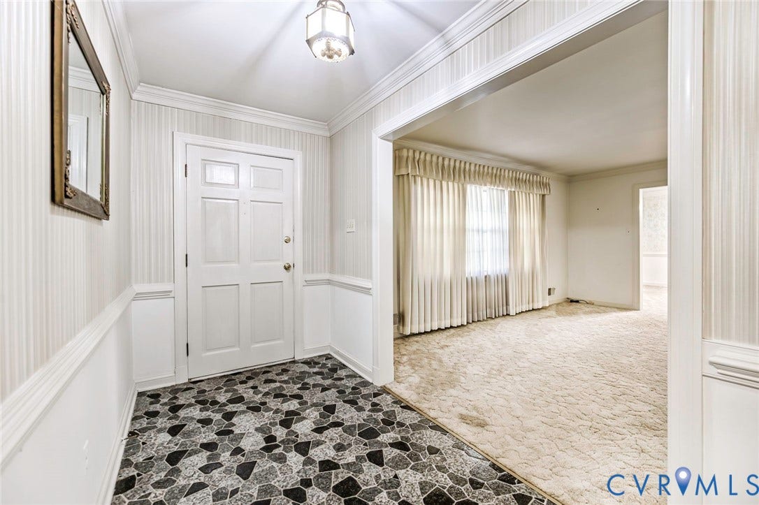 4511 Inca Drive, Ampthill, VA 23237 Foyer featuring stone-patterned tile flooring, chair rail molding, wallpapered walls, crown molding, and a built-in overhead light fixture