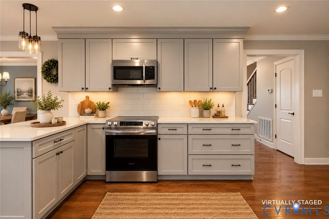 2137 Scarlet Mill Lane, Powhatan, VA 23139 Kitchen featuring light gray shaker-style cabinetry, white subway tile backsplash, stainless steel appliances, light-toned solid surface countertops, and wood-finish flooring