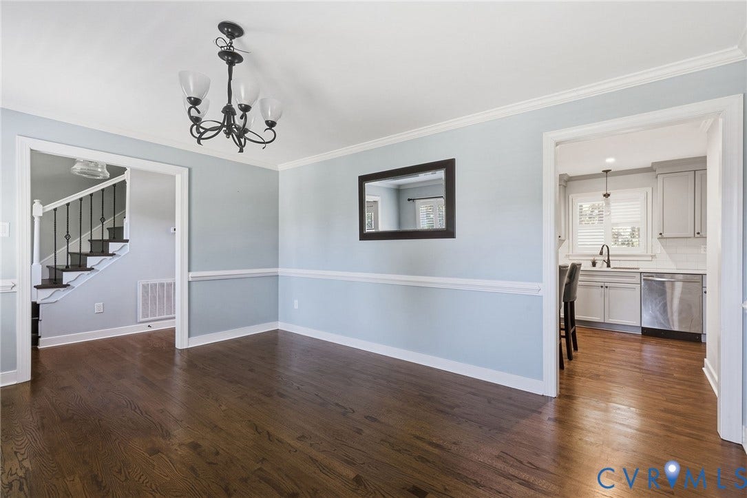 2137 Scarlet Mill Lane, Powhatan, VA 23139 Dining area featuring dark wood-finish flooring, chair rail molding, crown molding, and a multi-arm chandelier